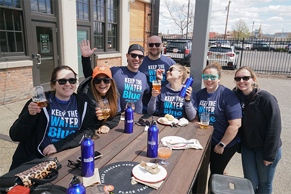 Group photo of employees at a picnic table
