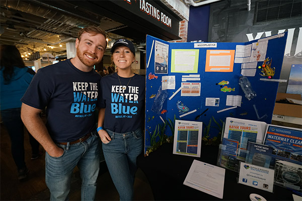 Two employees at a Keep the Water Blue information booth
